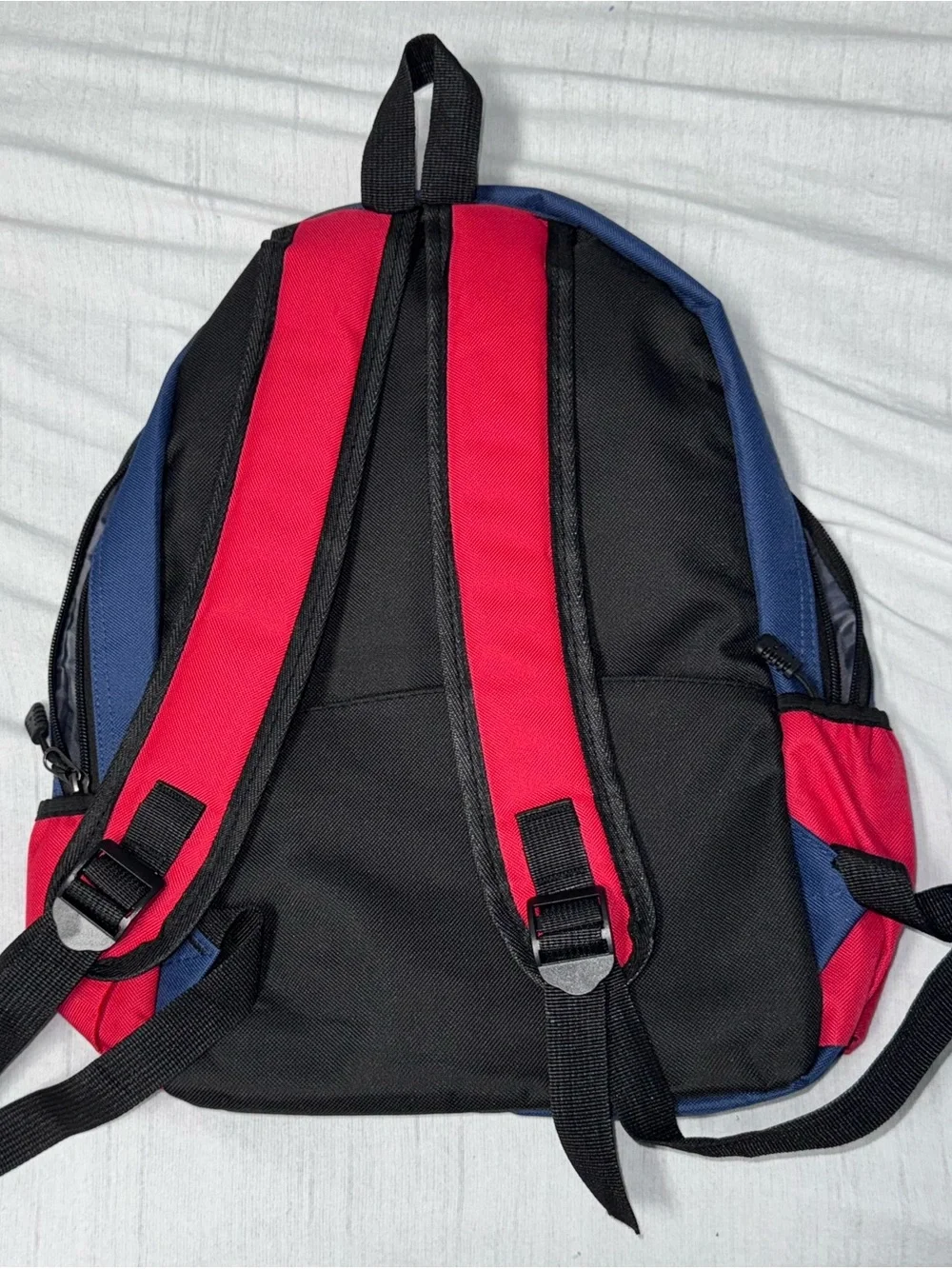 DePaul University navy blue and red backpack with white 'DEPAUL’ embroidered in